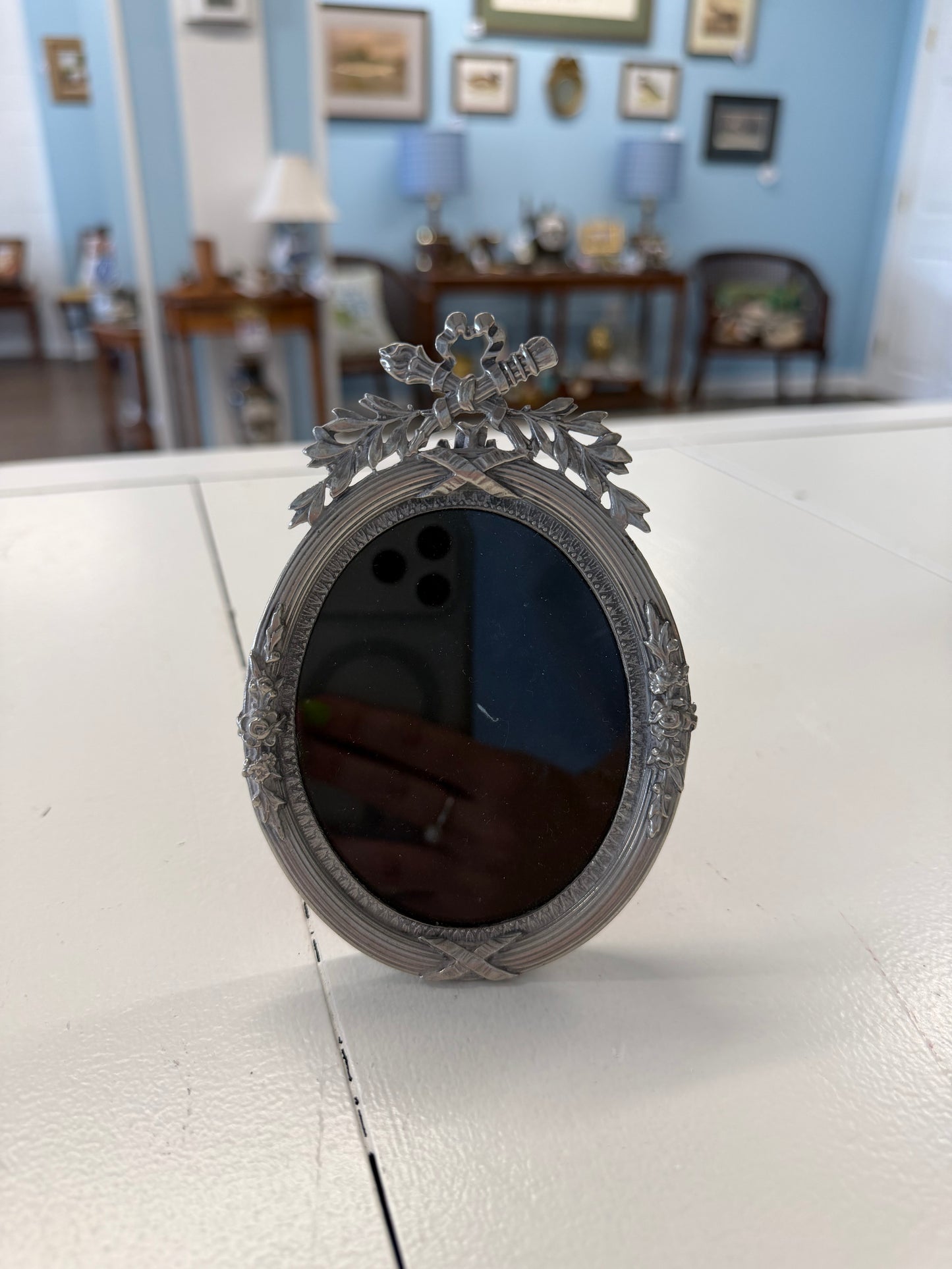 Ornate silver bow frame